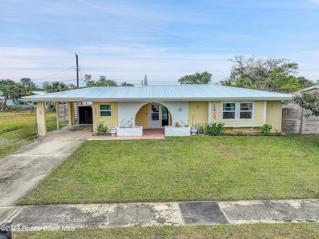 ranch-style home with a carport and a front yard