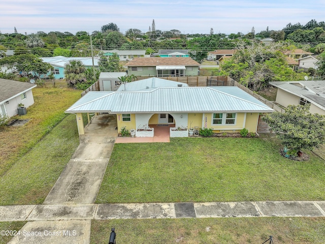 view of front of home with a front lawn and a carport