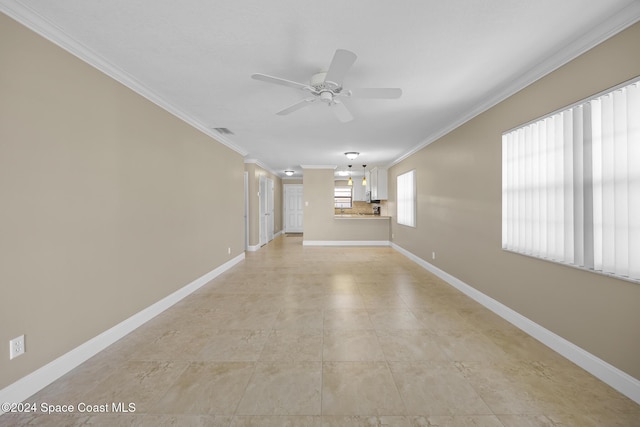 unfurnished room featuring ceiling fan and ornamental molding