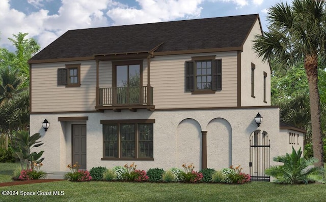 view of front of house featuring a balcony and a front lawn