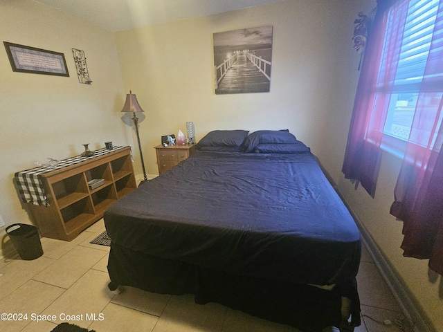 bedroom with light tile patterned floors