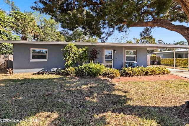 view of front of home featuring a carport and a front lawn