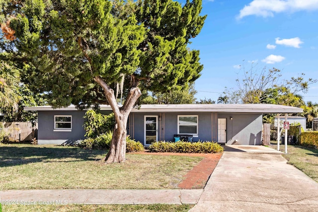 ranch-style house with a front lawn and a carport