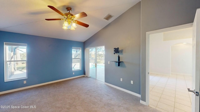 empty room with ceiling fan, light colored carpet, and lofted ceiling