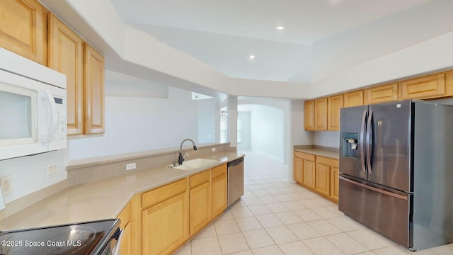 kitchen featuring appliances with stainless steel finishes, light brown cabinets, light tile patterned floors, and sink