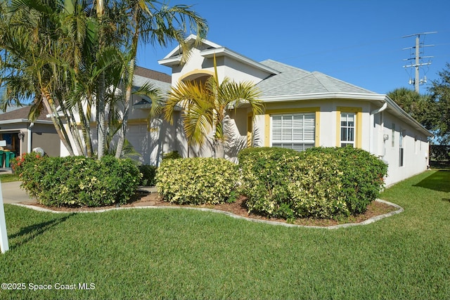 view of side of home with a yard and a garage