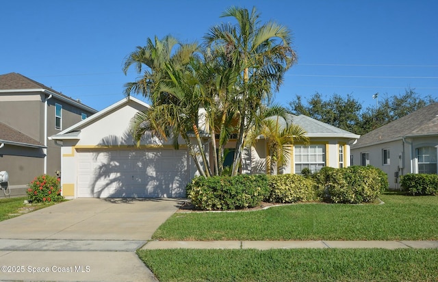 view of front of home featuring a front yard and a garage