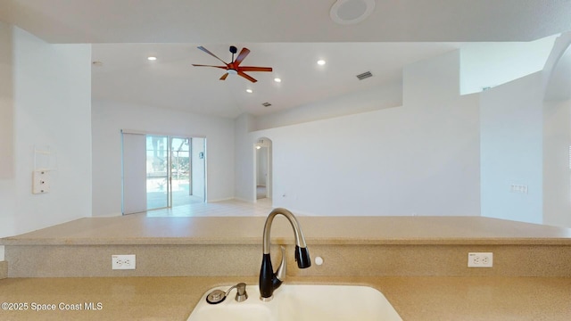 kitchen with ceiling fan, lofted ceiling, and sink