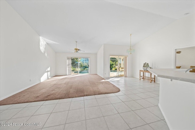 unfurnished living room with light colored carpet, ceiling fan, and lofted ceiling