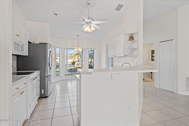 kitchen with white cabinetry, kitchen peninsula, lofted ceiling, white appliances, and a breakfast bar area