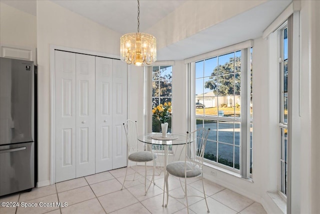 dining area featuring light tile patterned floors and a notable chandelier