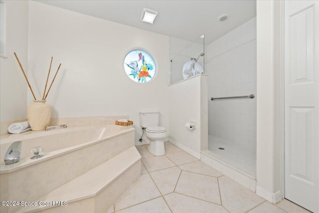 bathroom with a tile shower, tile patterned floors, and toilet