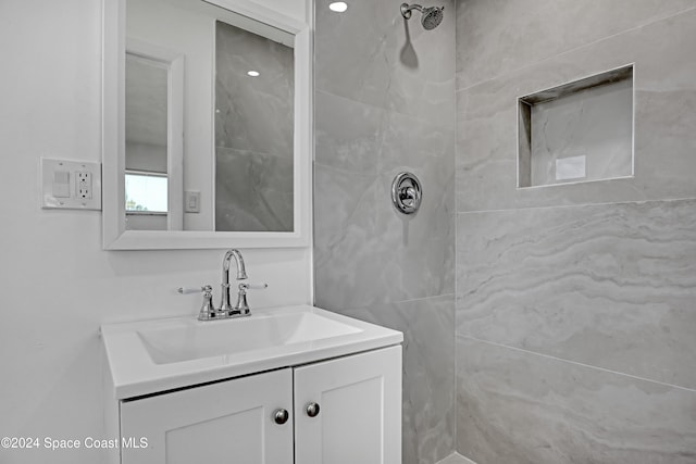 bathroom featuring vanity and tiled shower