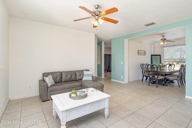 living room with ceiling fan and light tile patterned flooring