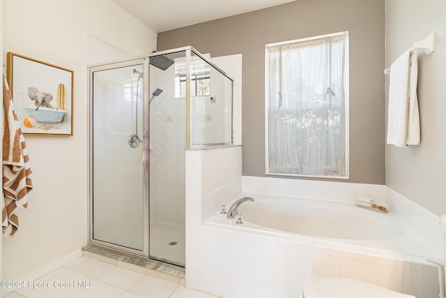 bathroom featuring plus walk in shower and tile patterned floors