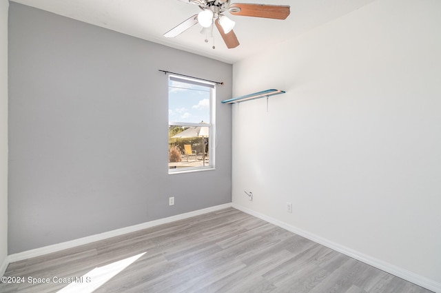 empty room with light hardwood / wood-style floors and ceiling fan