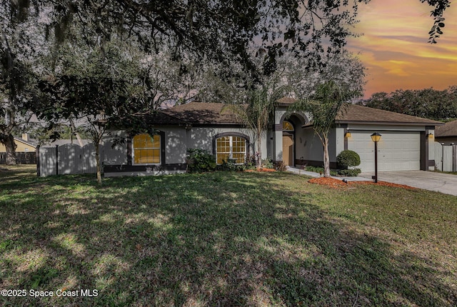 view of front of property with a lawn and a garage