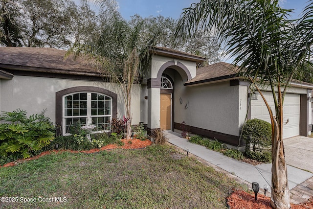 view of front of home with a garage and a front yard