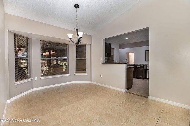 unfurnished dining area featuring vaulted ceiling, a textured ceiling, light tile patterned floors, and an inviting chandelier