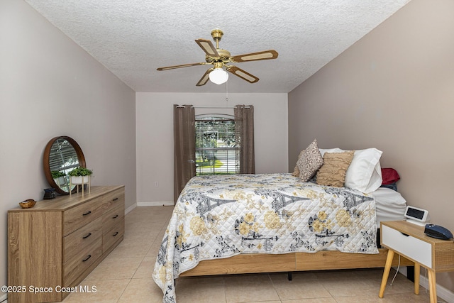 bedroom with ceiling fan, a textured ceiling, and light tile patterned flooring