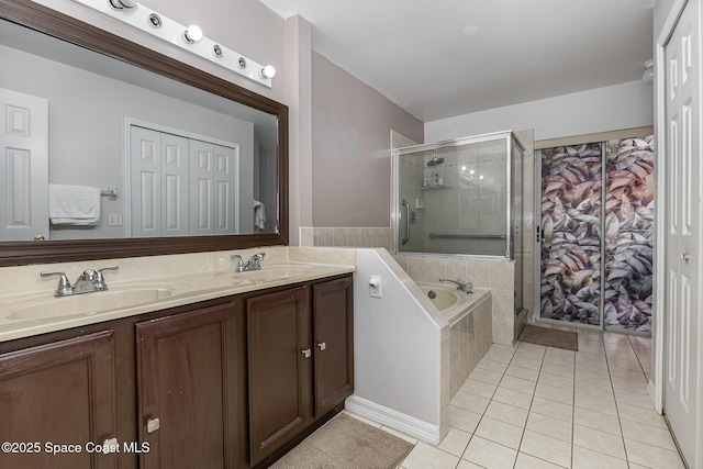 bathroom with tile patterned floors, vanity, and separate shower and tub