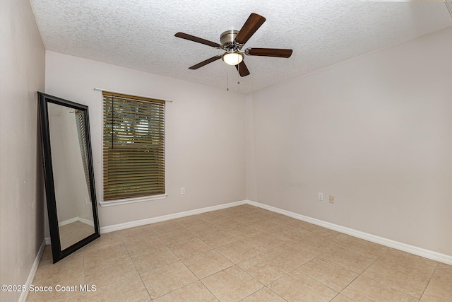 tiled empty room with a textured ceiling and ceiling fan