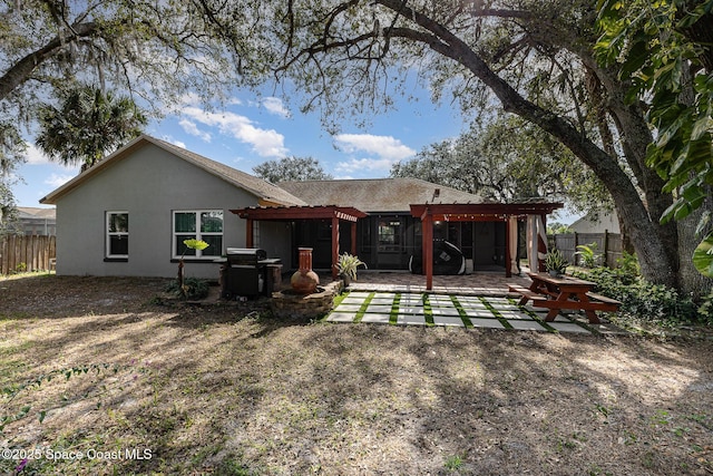 rear view of property with a pergola and a patio