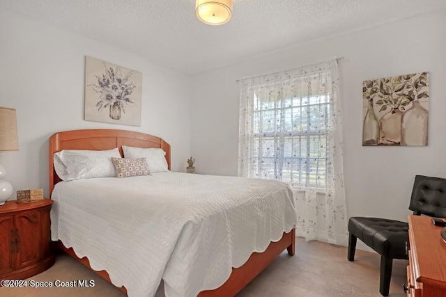 carpeted bedroom with a textured ceiling