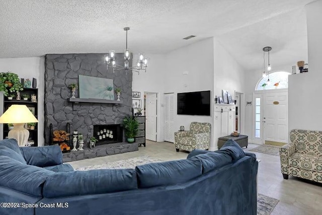 living room featuring a stone fireplace, high vaulted ceiling, a chandelier, and a textured ceiling