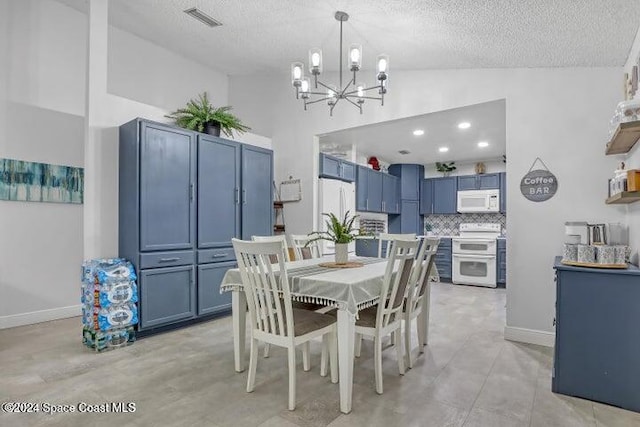 dining area featuring light tile patterned floors, a textured ceiling, high vaulted ceiling, and a chandelier