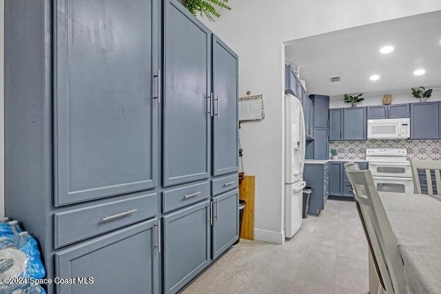 kitchen with decorative backsplash, light tile patterned flooring, and white appliances