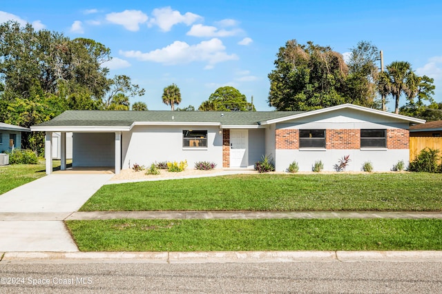 ranch-style house featuring central AC, a front lawn, and a carport