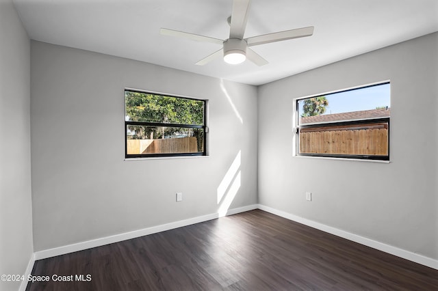 spare room with dark hardwood / wood-style floors, plenty of natural light, and ceiling fan