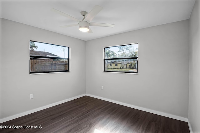 spare room featuring ceiling fan and dark hardwood / wood-style floors