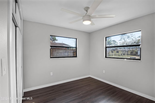 unfurnished bedroom featuring ceiling fan, a closet, and dark hardwood / wood-style floors