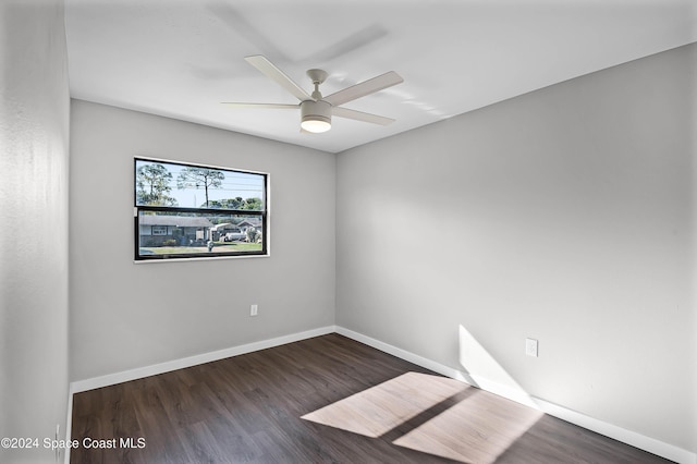 empty room with ceiling fan and dark wood-type flooring