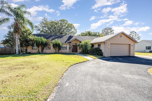 ranch-style house with a garage and a front yard