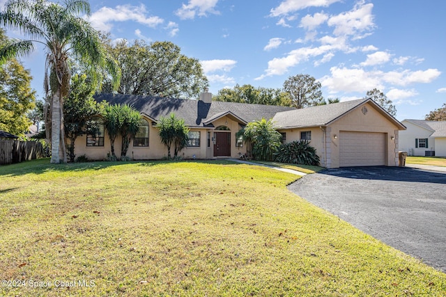 ranch-style home with a front yard and a garage