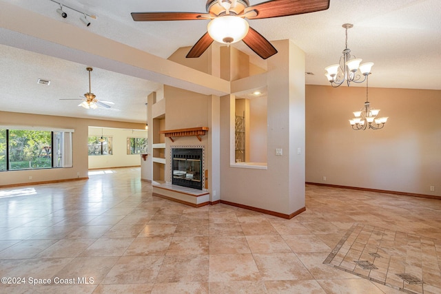 unfurnished living room featuring built in shelves, lofted ceiling, a textured ceiling, and ceiling fan with notable chandelier