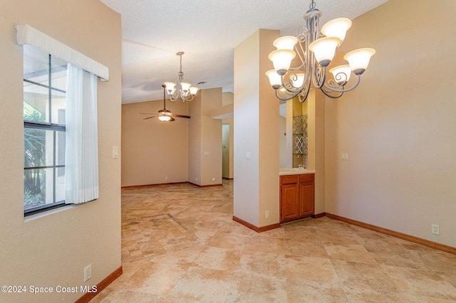 spare room with lofted ceiling and ceiling fan with notable chandelier