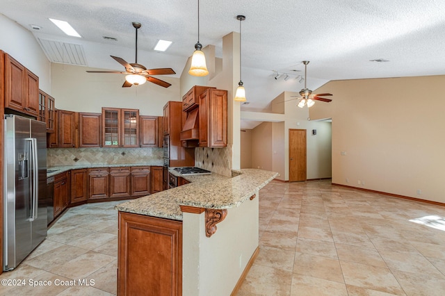 kitchen with light stone countertops, tasteful backsplash, kitchen peninsula, a kitchen bar, and appliances with stainless steel finishes