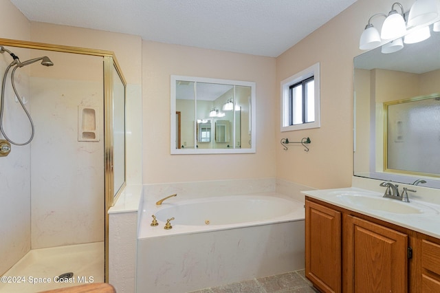 bathroom featuring vanity, a textured ceiling, and shower with separate bathtub