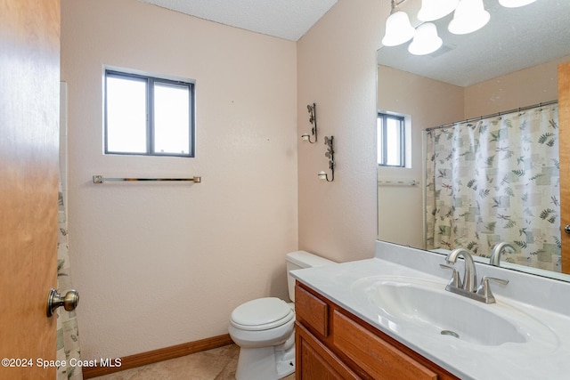 bathroom with tile patterned floors, vanity, and toilet