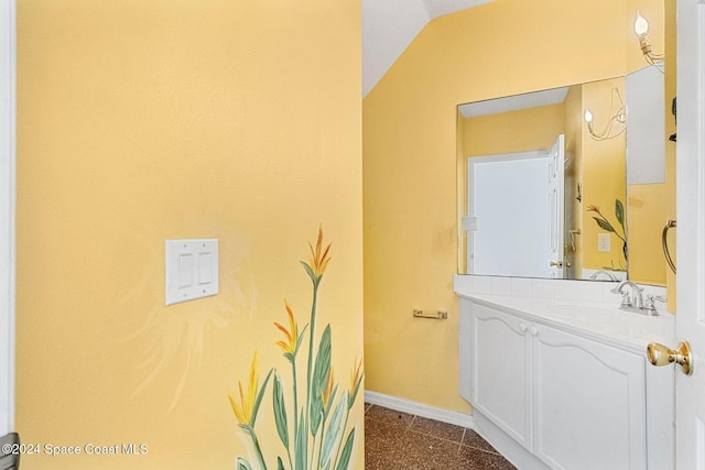 bathroom with tile patterned flooring, vanity, and baseboards