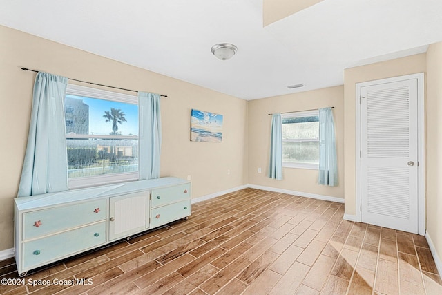 interior space with visible vents, baseboards, and wood finished floors