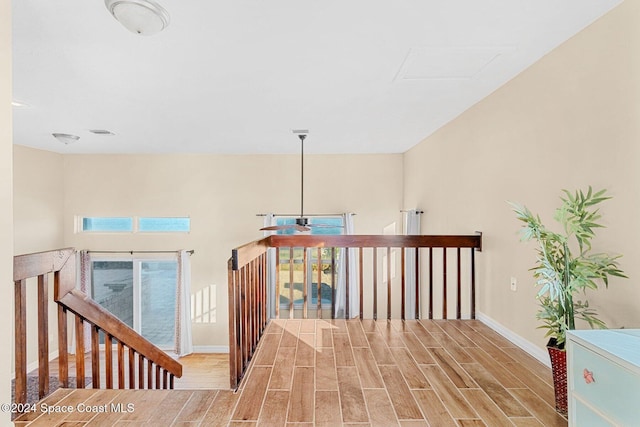 hall featuring wood tiled floor and baseboards