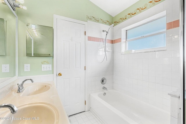 bathroom with lofted ceiling, tile patterned flooring, a sink, and bathing tub / shower combination