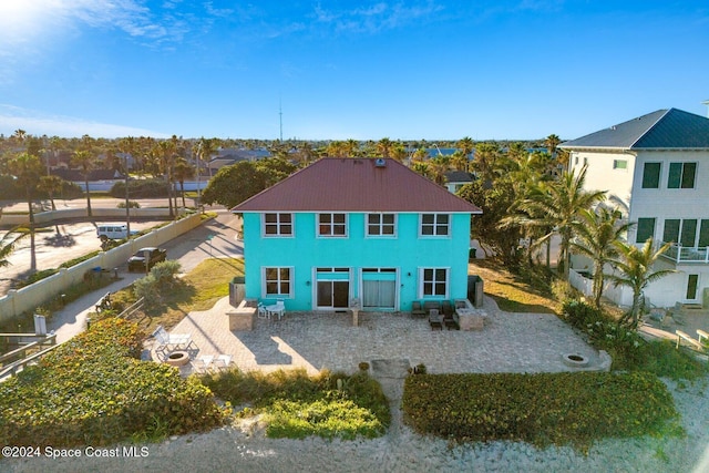 rear view of house featuring a fenced backyard and a patio