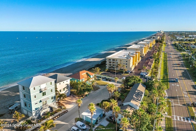 drone / aerial view featuring a view of the beach and a water view