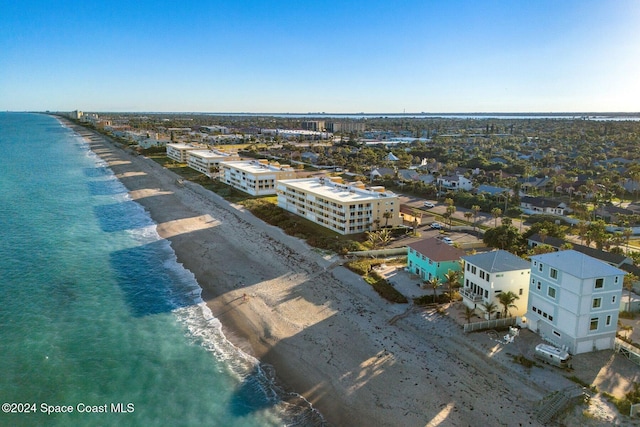 bird's eye view featuring a water view and a view of the beach